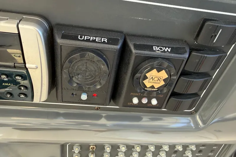 Slide: The Image of Control panel of a 2001 Tiara Yachts 5200 Express, featuring electronic and navigation controls. - 11