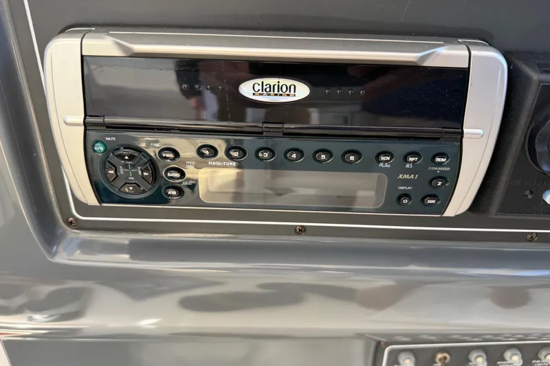 Slide: The Image of Clarion audio system on 2001 Tiara Yachts 5200 Express dashboard. - 15