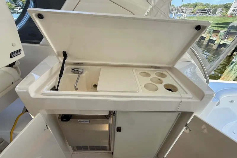 Slide: The Image of 2001 Tiara Yachts 5200 Express yacht kitchenette with sink and storage compartments. - 16