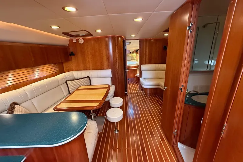 Slide: The Image of Luxurious interior of 2001 Tiara Yachts 5200 Express with wood finishes and plush seating. - 17