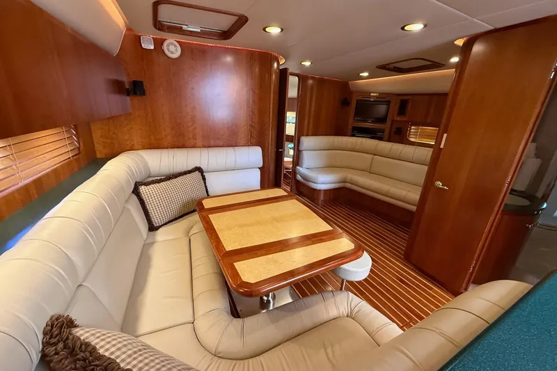 Slide: The Image of Luxurious interior of 2001 Tiara Yachts 5200 Express with elegant wood finishes and plush seating. - 18