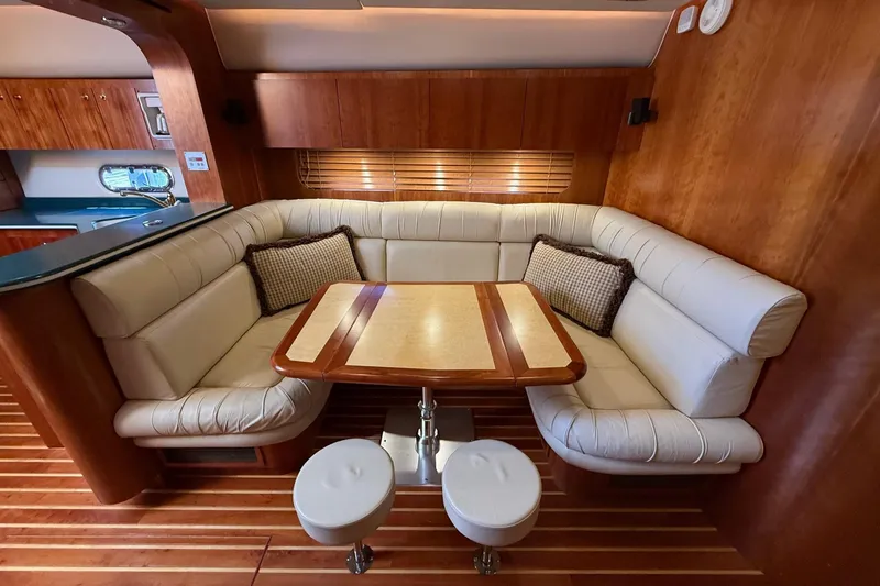 Slide: The Image of Luxurious 2001 Tiara Yachts 5200 Express interior with elegant seating and wooden accents. - 19