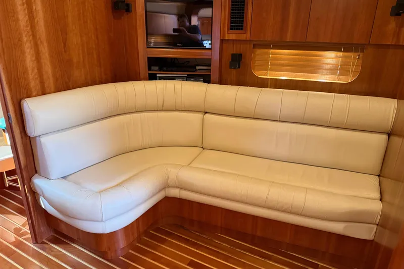 Slide: The Image of Luxurious interior of 2001 Tiara Yachts 5200 Express with cream leather seating and wooden accents. - 21