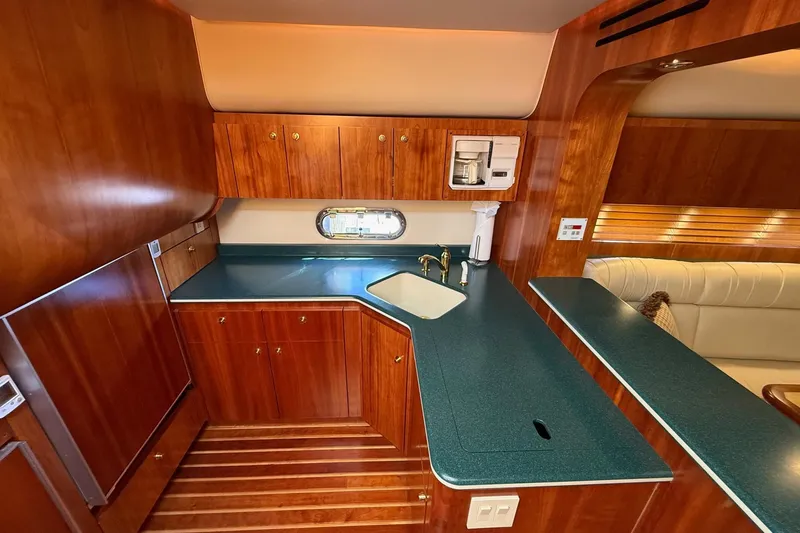 Slide: The Image of Luxurious 2001 Tiara Yachts 5200 Express interior with wood cabinetry and modern amenities. - 23