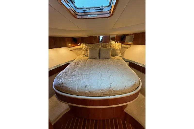 Slide: The Image of Luxurious cabin interior of 2001 Tiara Yachts 5200 Express with plush bedding. - 26