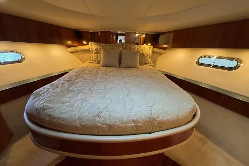 Slide: The Image of Luxurious bedroom interior of 2001 Tiara Yachts 5200 Express with elegant bedding. - 27