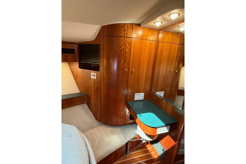Slide: The Image of Luxurious 2001 Tiara Yachts 5200 Express cabin interior with wood paneling and modern amenities. - 30