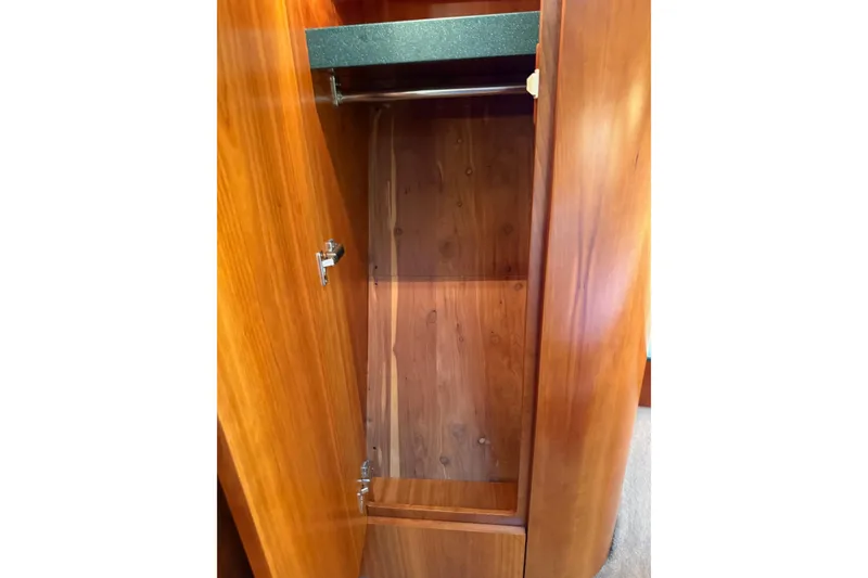 Slide: The Image of Wooden closet interior on a 2001 Tiara Yachts 5200 Express. - 31