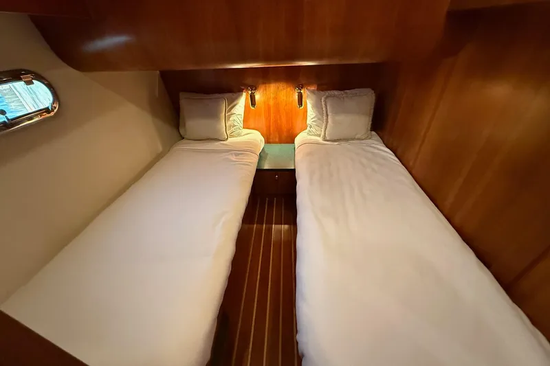 Slide: The Image of Twin beds in a cozy cabin of a 2001 Tiara Yachts 5200 Express. - 32