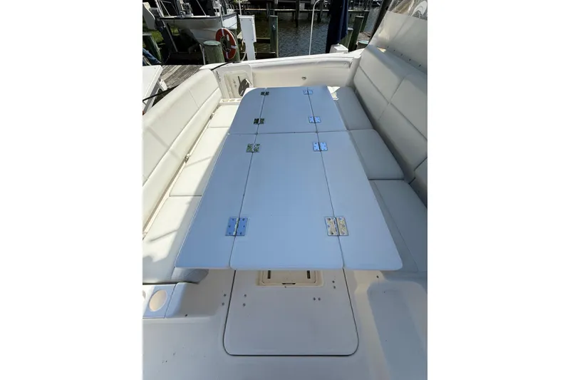 Slide: The Image of 2001 Tiara Yachts 5200 Express interior with foldable table and cushioned seating. - 36