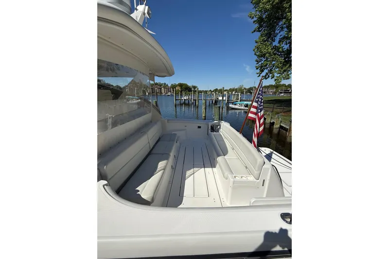 Slide: The Image of 2001 Tiara Yachts 5200 Express with spacious deck, docked by a serene waterfront. - 37