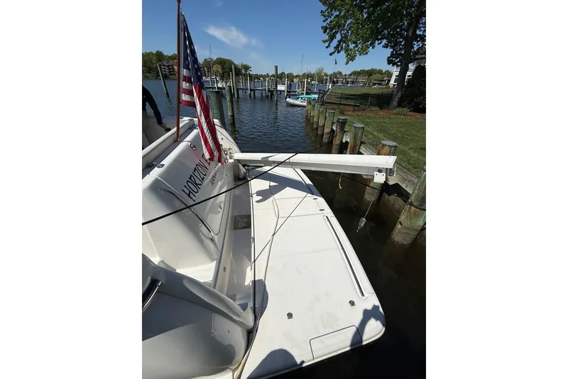 Slide: The Image of 2001 Tiara Yachts 5200 Express docked, featuring American flag and marina view. - 38