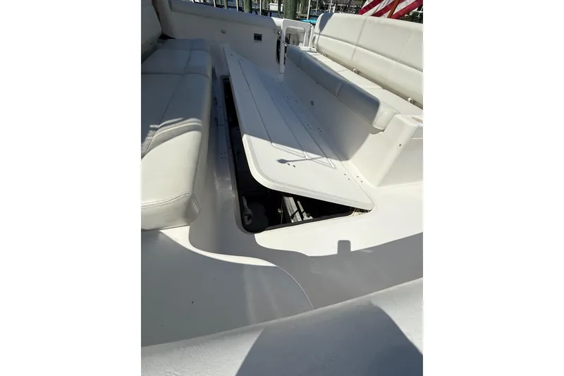 Slide: The Image of 2001 Tiara Yachts 5200 Express interior seating with storage compartment open. - 40