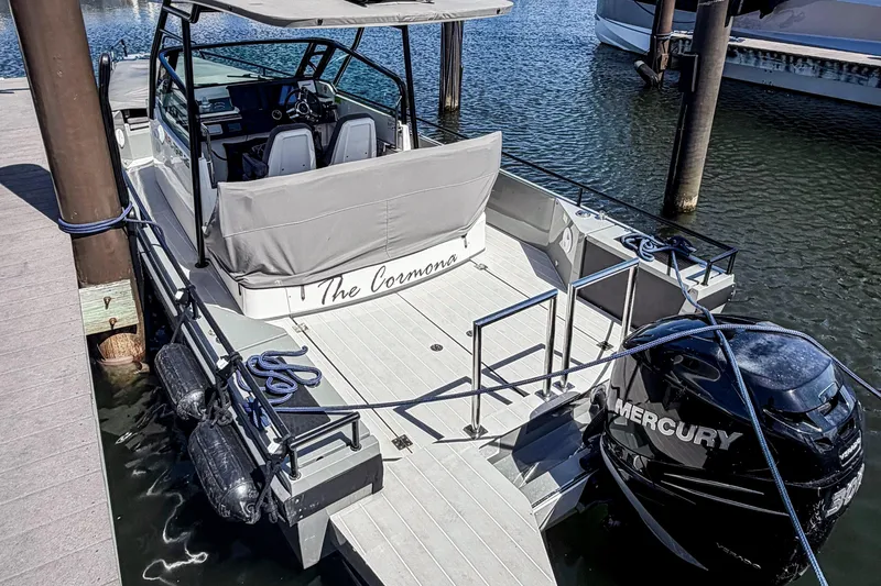 The Image of 2017 Axopar 28 T-Top boat docked, featuring Mercury outboard engine and sleek design. - 0