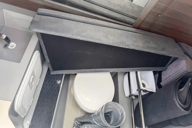 Slide: The Image of Interior view of 2017 Axopar 28 T-Top boat showing storage and toilet area. - 22