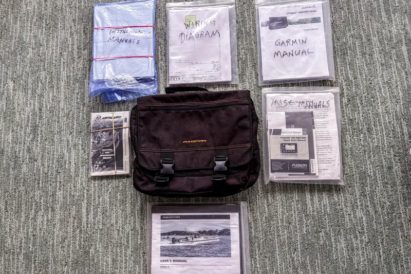 Slide: The Image of Manuals and documents for 2017 Axopar 28 T-Top, including Garmin and Mercury guides. - 27