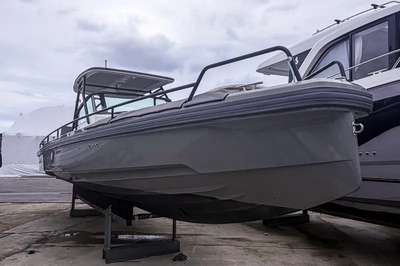 Slide: The Image of 2017 Axopar 28 T-Top boat on dry dock, overcast sky background. - 4
