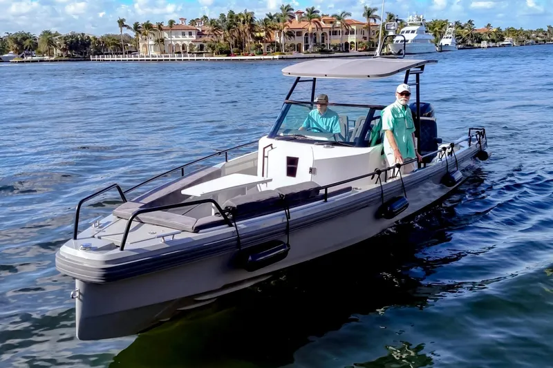 The Image of 2017 Axopar 28 T-Top boat cruising on a sunny day near luxury waterfront homes. - 0