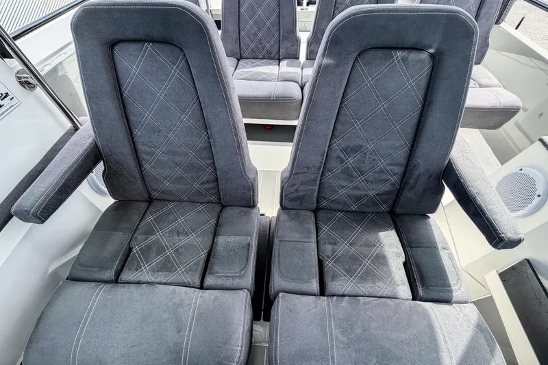 Slide: The Image of 2017 Axopar 28 T-Top boat interior with stylish gray seating and diamond stitching. - 8