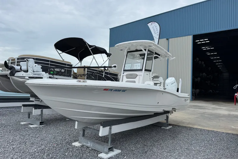 The Image of 2026 Caymas 26 HB boat displayed outside a marine storage facility. - 1