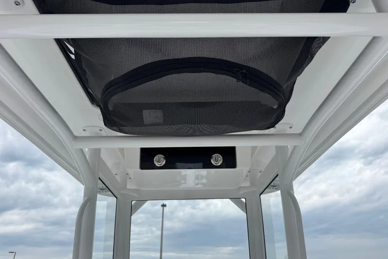 Slide: The Image of 2026 Caymas 26 HB boat interior with overhead storage and sleek design. - 14