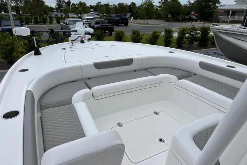 Slide: The Image of 2026 Caymas 26 HB boat interior with cushioned seating and storage compartments. - 18