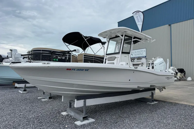 Slide: The Image of 2026 Caymas 26 HB boat displayed at Grander Marine dealership. - 2