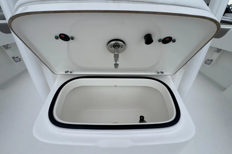 Slide: The Image of Open storage compartment on 2026 Caymas 26 HB boat, featuring a sleek white interior. - 21