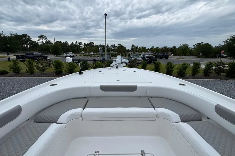 Slide: The Image of 2026 Caymas 26 HB boat with spacious seating and sleek design, parked outdoors. - 22