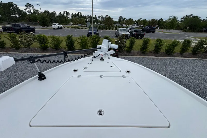 Slide: The Image of 2026 Caymas 26 HB boat bow view in a parking lot setting. - 23