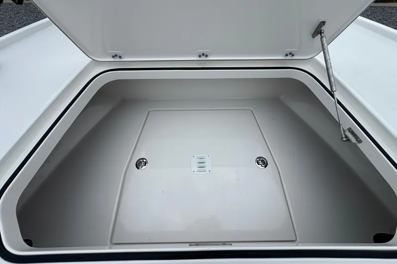 Slide: The Image of Open storage compartment of 2026 Caymas 26 HB boat, showcasing spacious interior design. - 24