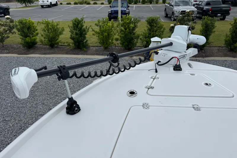 Slide: The Image of 2026 Caymas 26 HB boat with trolling motor on deck, parked in lot. - 25
