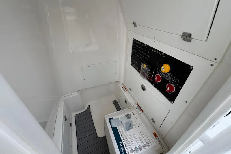 Slide: The Image of Interior view of 2026 Caymas 26 HB boat showing electrical panel and storage area. - 29