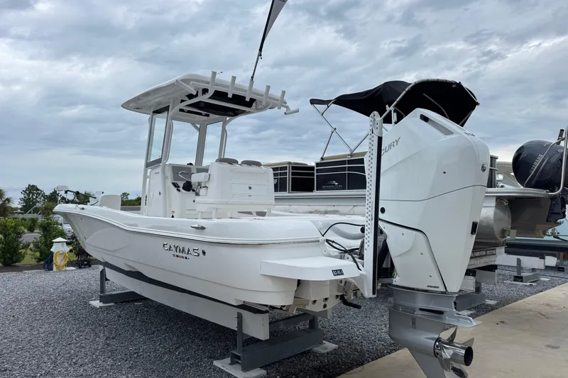 Slide: The Image of 2026 Caymas 26 HB boat with Mercury engine on display under cloudy sky. - 3