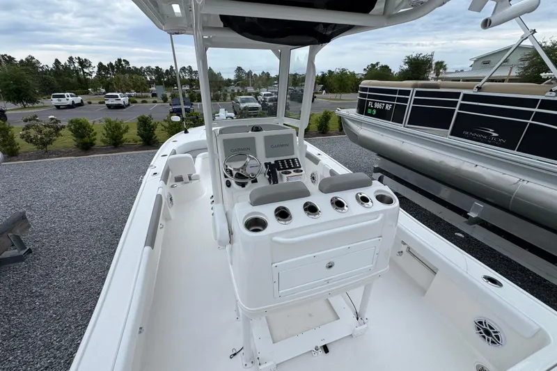 Slide: The Image of 2026 Caymas 26 HB boat interior with steering console and navigation equipment. - 8