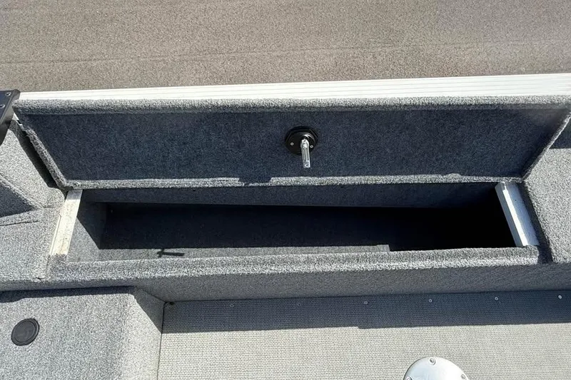 Slide: The Image of 2022 G3 Angler V164 C boat storage compartment, open and empty, with gray interior. - 10