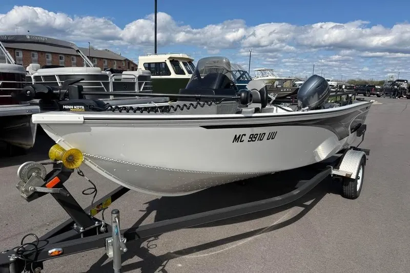 Slide: The Image of 2022 G3 Angler V164 C fishing boat on trailer, parked outdoors. - 2