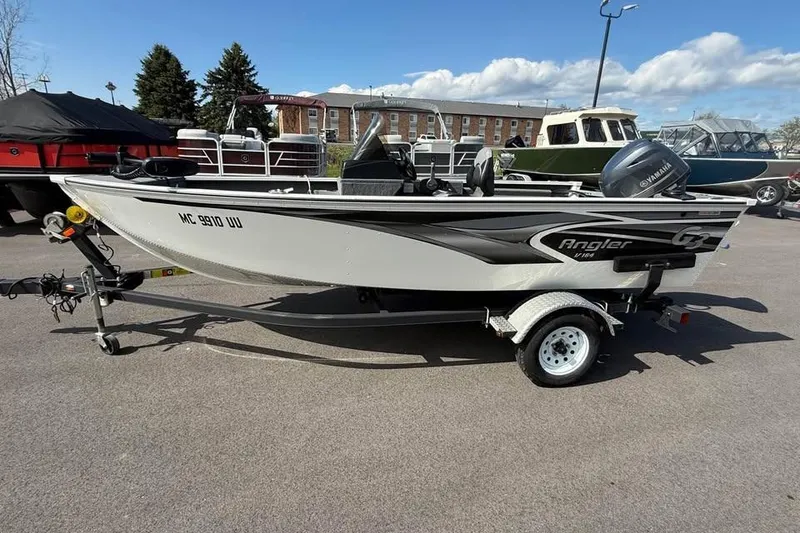 Slide: The Image of 2022 G3 Angler V164 C fishing boat on trailer, parked outdoors. - 4