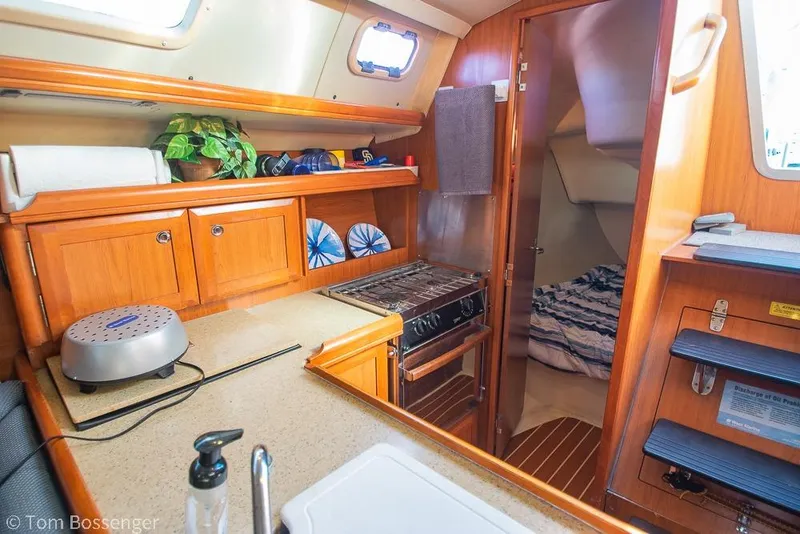 Slide: The Image of Interior of a 2008 Hunter 31 sailboat with kitchen and cozy cabin. - 10
