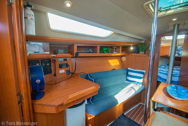 Slide: The Image of Interior of a 2008 Hunter 31 sailboat with cozy seating and navigation station. - 12