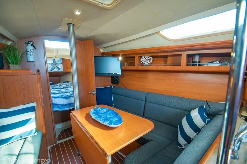 Slide: The Image of Interior of a 2008 Hunter 31 sailboat with cozy seating and nautical decor. - 13