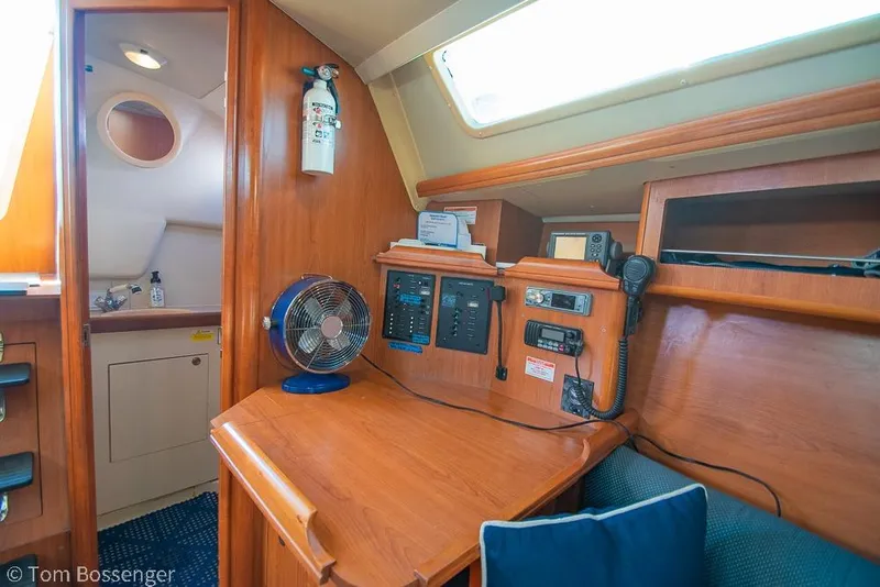 Slide: The Image of Interior of a 2008 Hunter 31 sailboat with navigation equipment and wooden finish. - 14