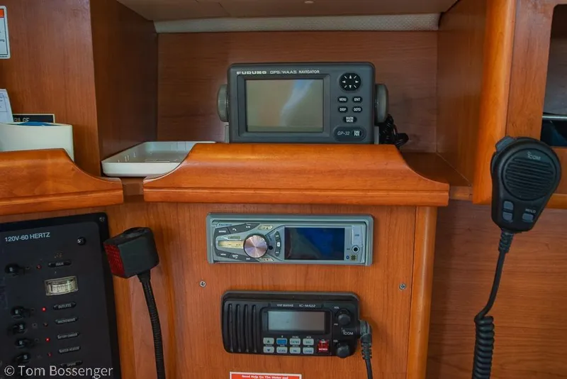 Slide: The Image of Navigation and communication equipment inside a 2008 Hunter 31 sailboat cabin. - 15