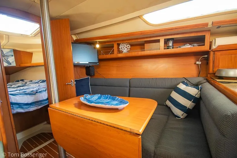 Slide: The Image of Cozy interior of 2008 Hunter 31 sailboat with dining area and cabin. - 16