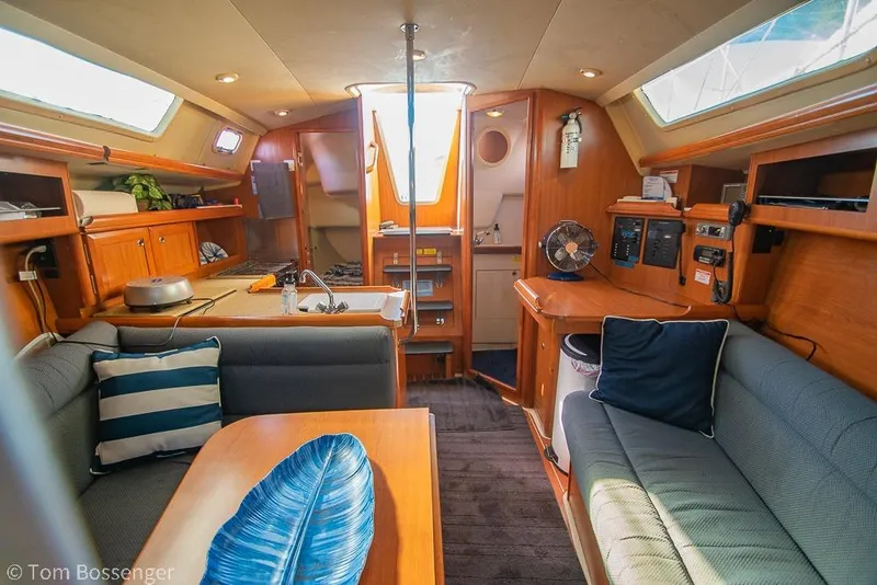 Slide: The Image of Interior of a 2008 Hunter 31 sailboat with cozy seating and wooden cabinetry. - 17