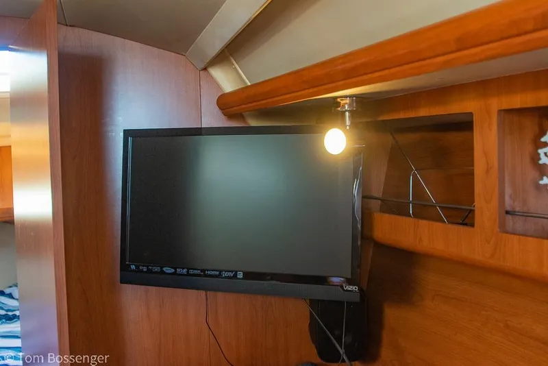 Slide: The Image of Flat-screen TV in 2008 Hunter 31 yacht interior with wooden paneling. - 19