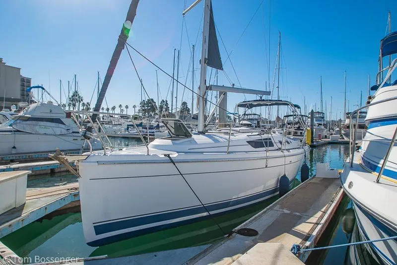 Slide: The Image of 2008 Hunter 31 sailboat docked in a marina under clear blue skies. - 2