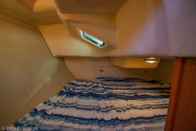 Slide: The Image of Cozy cabin interior of 2008 Hunter 31 sailboat with striped bedding. - 20