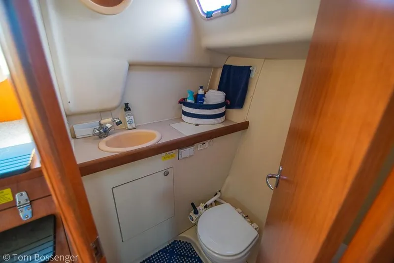 Slide: The Image of 2008 Hunter 31 yacht bathroom with sink, toilet, and toiletries. - 21