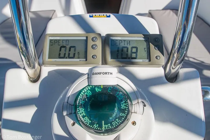 Slide: The Image of Boat dashboard with speedometer, depth gauge, and compass on a 2008 Hunter 31. - 24